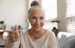 Smiling senior showing teeth.