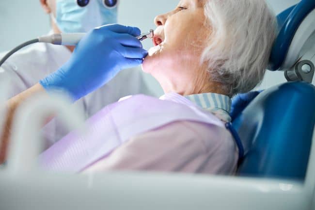 Senior woman getting dental treatment.