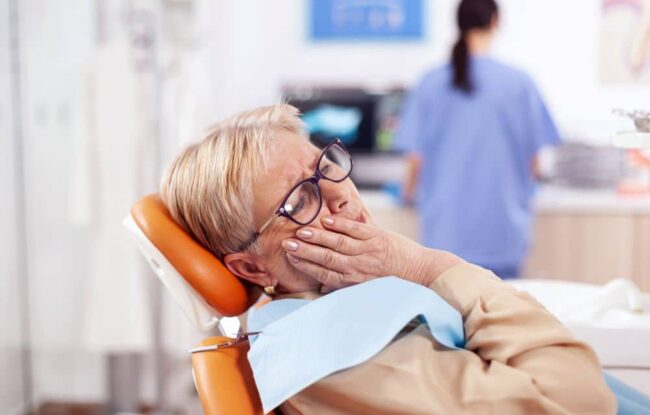 Elderly patient feeling afraid, nervous, or anxious about dental treatment.